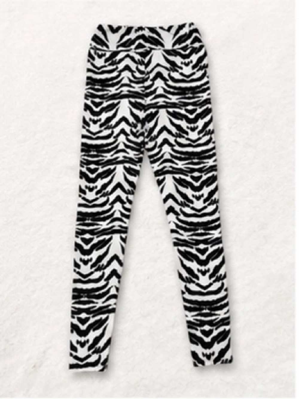 2 pairs of leggings one Sugar Skull Print and the other one is Zebra print.